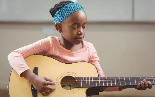 a girl playing a guitar