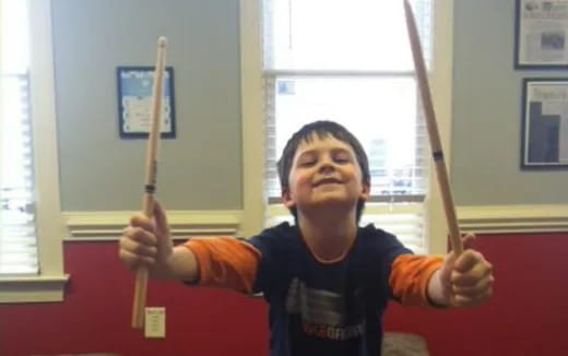 a boy holding a stick