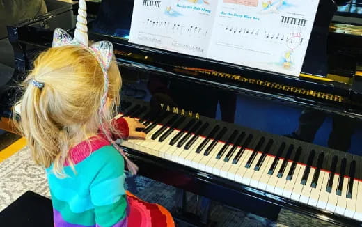 a girl playing a piano