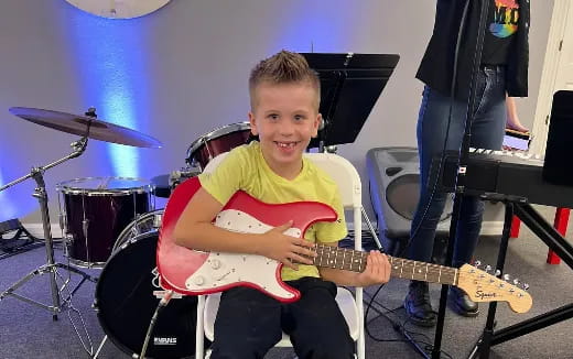 a boy playing a guitar