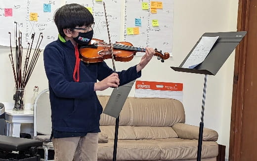 a boy playing a violin