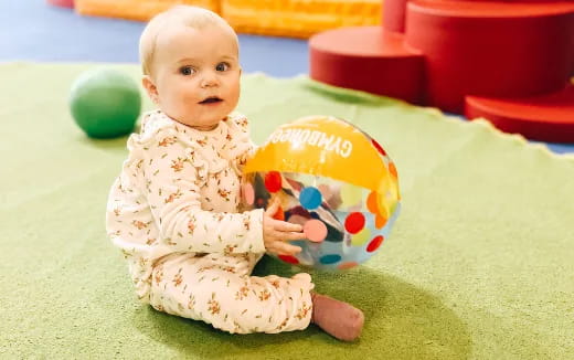 a baby holding a toy