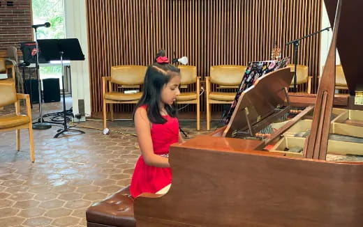 a girl playing a piano