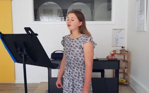 a girl standing in front of a microphone