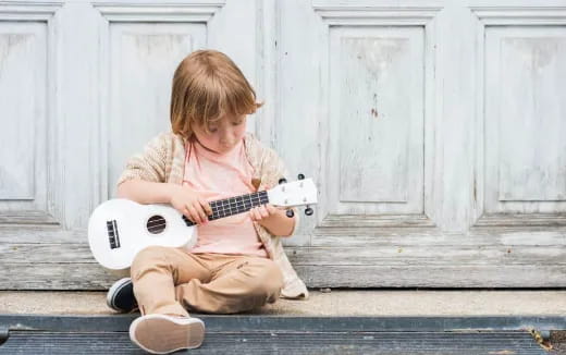 a child playing a guitar