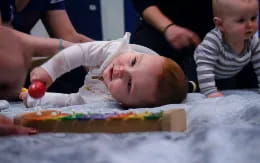 a baby lays on a table
