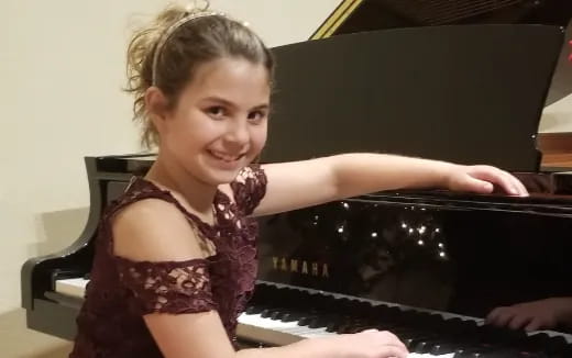 a girl playing a piano