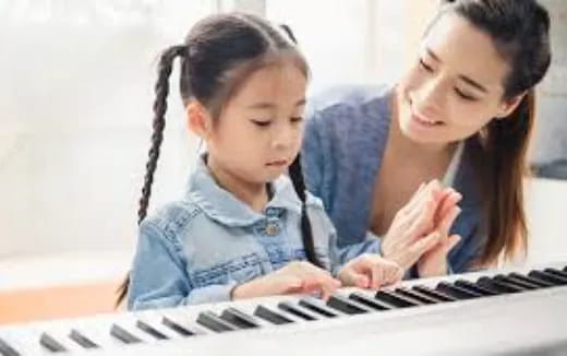 a person and a child looking at a computer screen