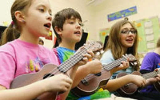 a group of kids playing guitars