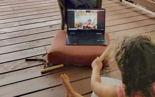 a child playing with a laptop