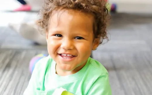 a child smiling at the camera