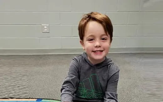 a boy sitting on the floor