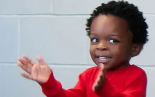 a child with their hands up