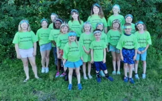 a group of girls in green shirts