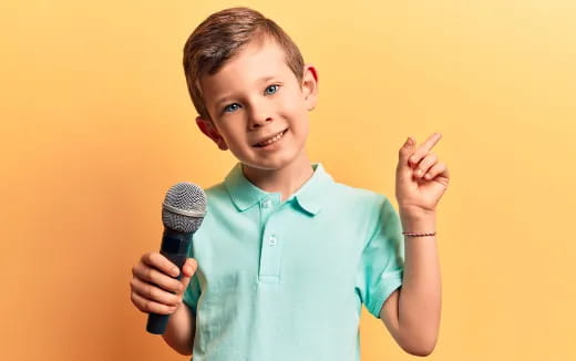 a boy holding a microphone