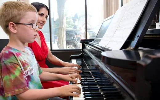 a group of kids playing piano
