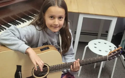 a girl playing a guitar