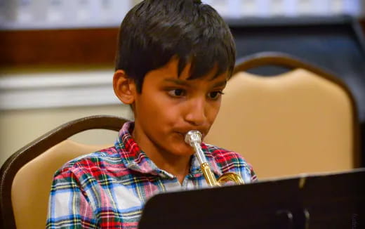 a boy sitting in a chair