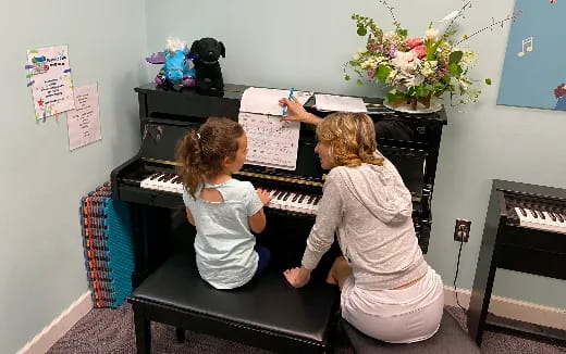 a person and a child playing piano