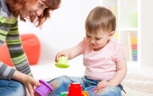 a person and a child playing with toys