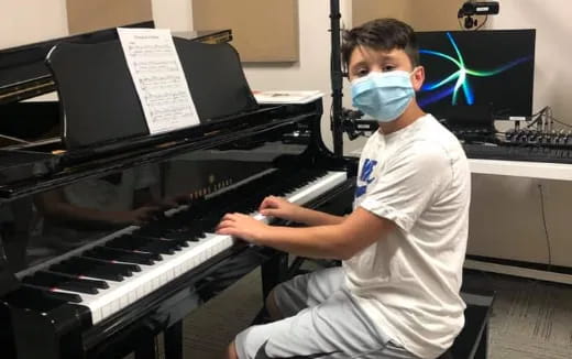 a boy playing a piano