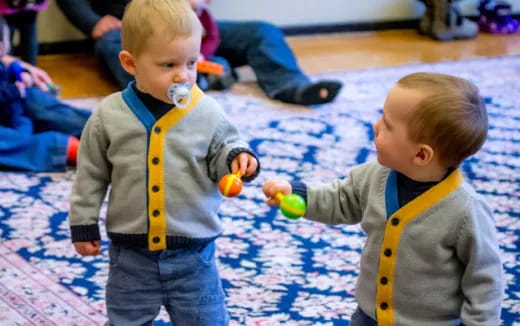 two boys playing with toys