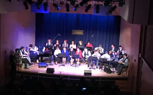 a group of people playing instruments on a stage