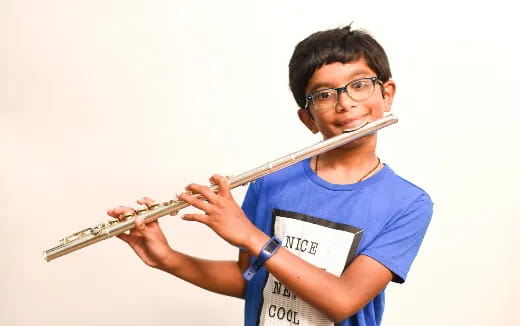 a boy playing a flute