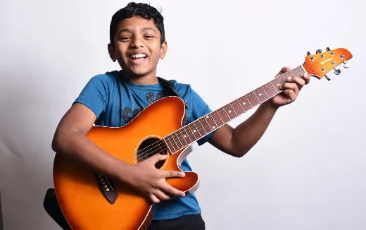 a boy playing a guitar