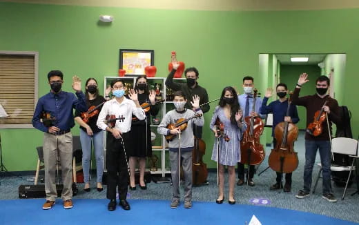 a group of people holding musical instruments