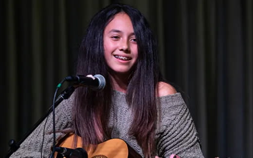 a person with long hair smiling