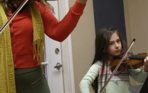 a woman playing a violin