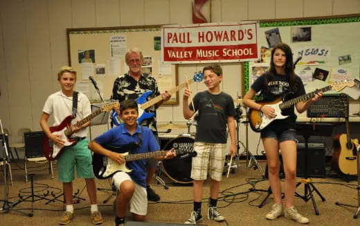 a group of people holding guitars