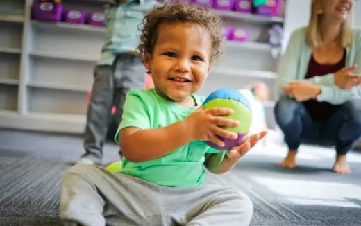 a child holding a ball