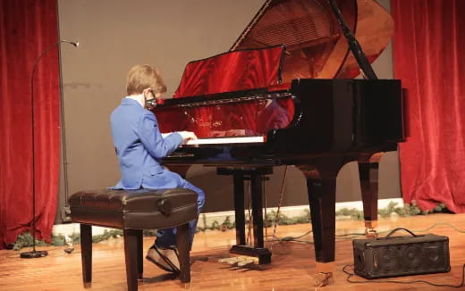 a person sitting at a piano