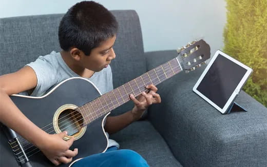a boy playing a guitar