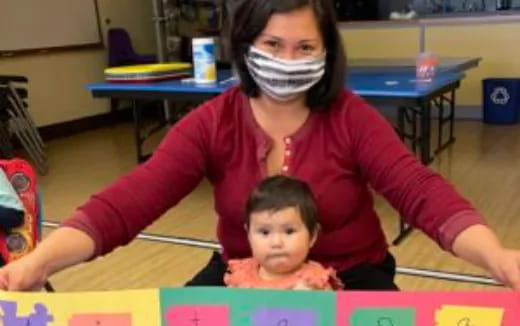 a person and a child in a classroom