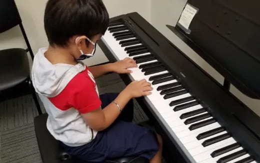 a boy playing a piano