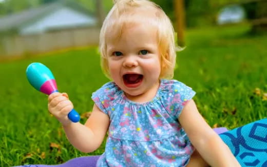 a baby holding a toy