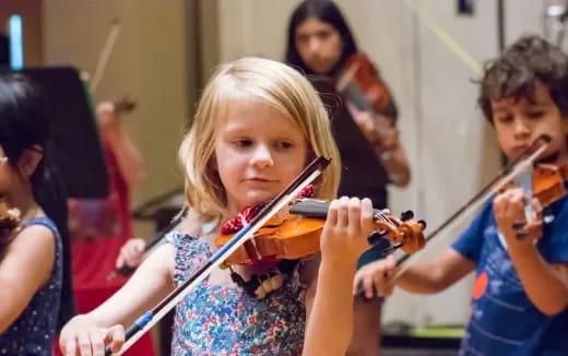 a girl playing a violin