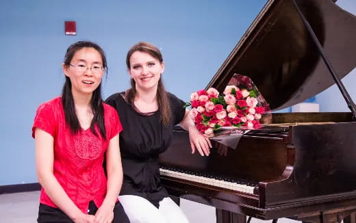 two women holding flowers