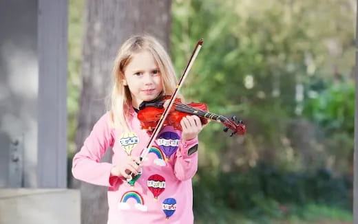 a girl playing a violin