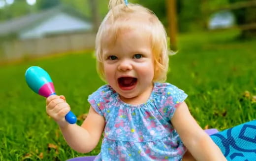 a baby holding a toy