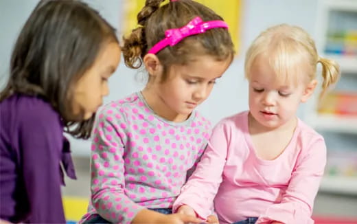 a group of girls looking at something