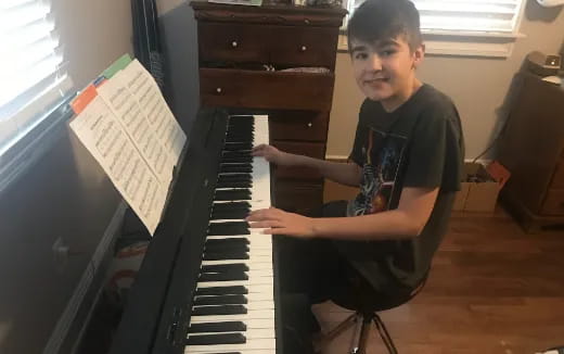 a boy playing a piano