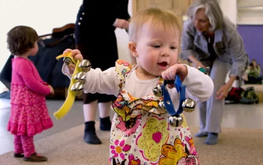 a baby holding a toy