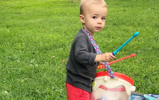 a baby holding a toy