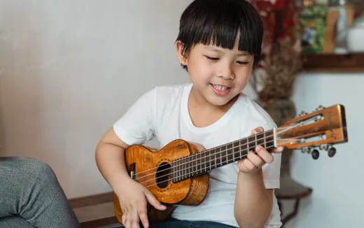 a child playing a guitar