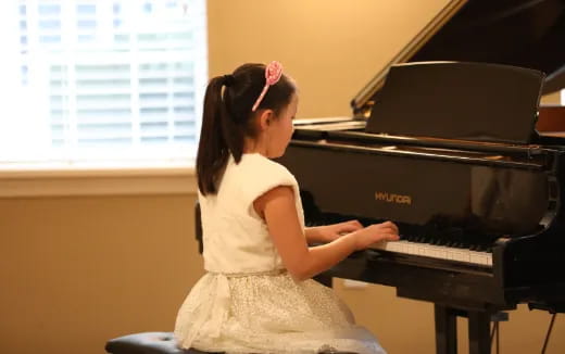 a girl playing a piano