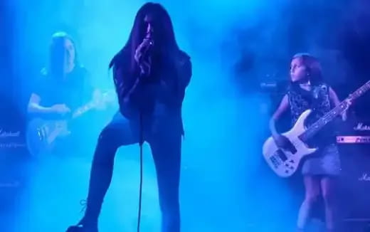 a person playing guitar on stage